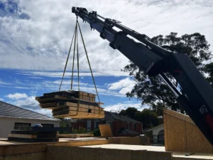 Crane truck services in Asheville lifting and delivering construction site materials