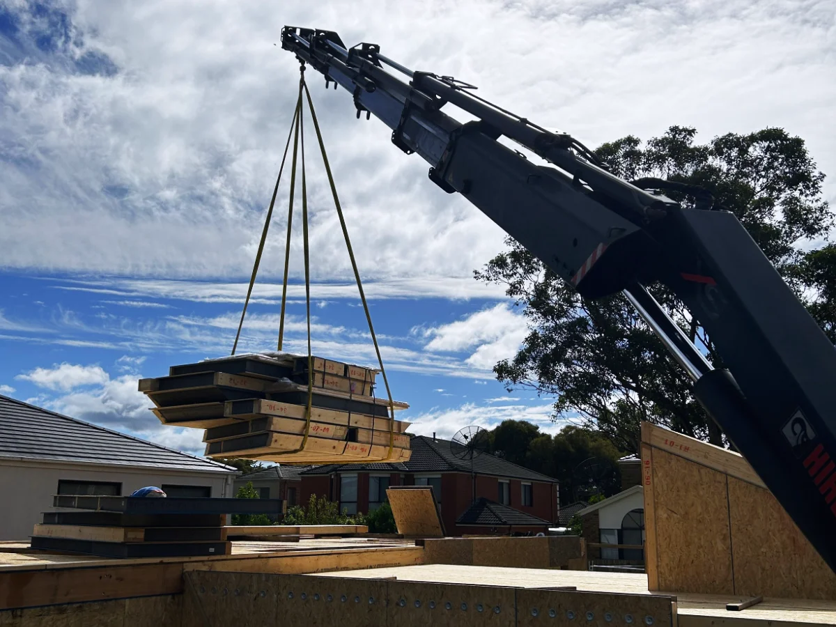 Crane truck services in Asheville lifting and delivering construction site materials