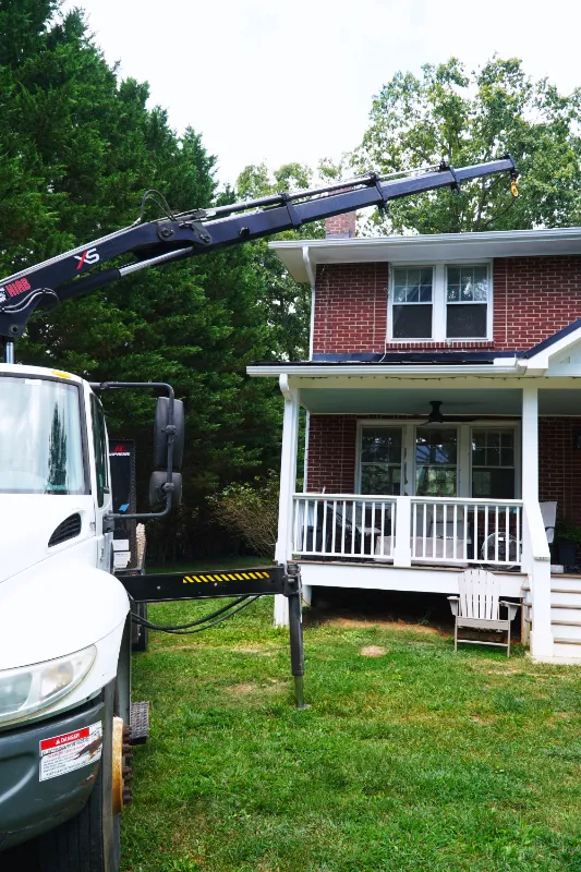 Truck-mounted crane with flatbed for lifting and hauling in the Asheville area