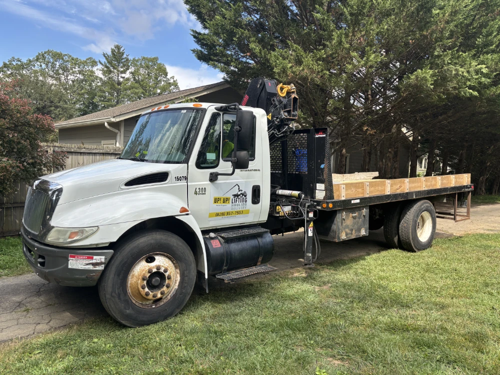 Crane truck and flatbed option for lifting and transporting heavy cargo