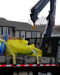 Dumpster bag pickup by crane truck in Asheville NC by Up! Up! Lifting