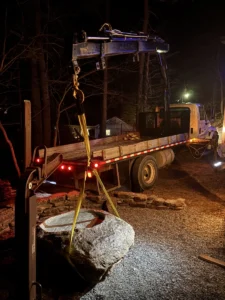 Asheville crane truck startup learns safety lesson placing a boulder for client.