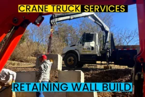 crane truck lifting placing precast concrete blocks for a retaining wall in asheville