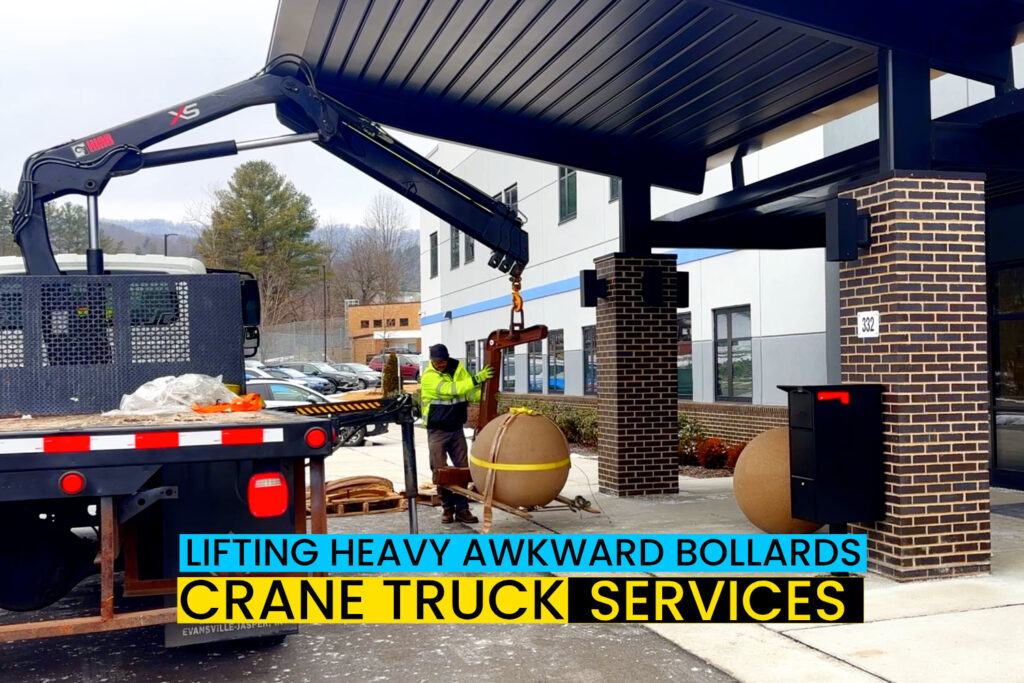 crane truck lifting and placing bollards heavy awkward cargo for commerical customer