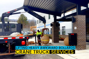 crane truck lifting and placing bollards heavy awkward cargo for commerical customer