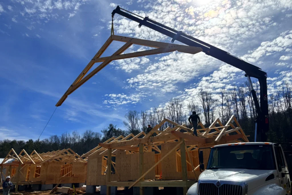 crane truck lifting trusses at  Hendersonville NC construction site by Up! Up! Lifting