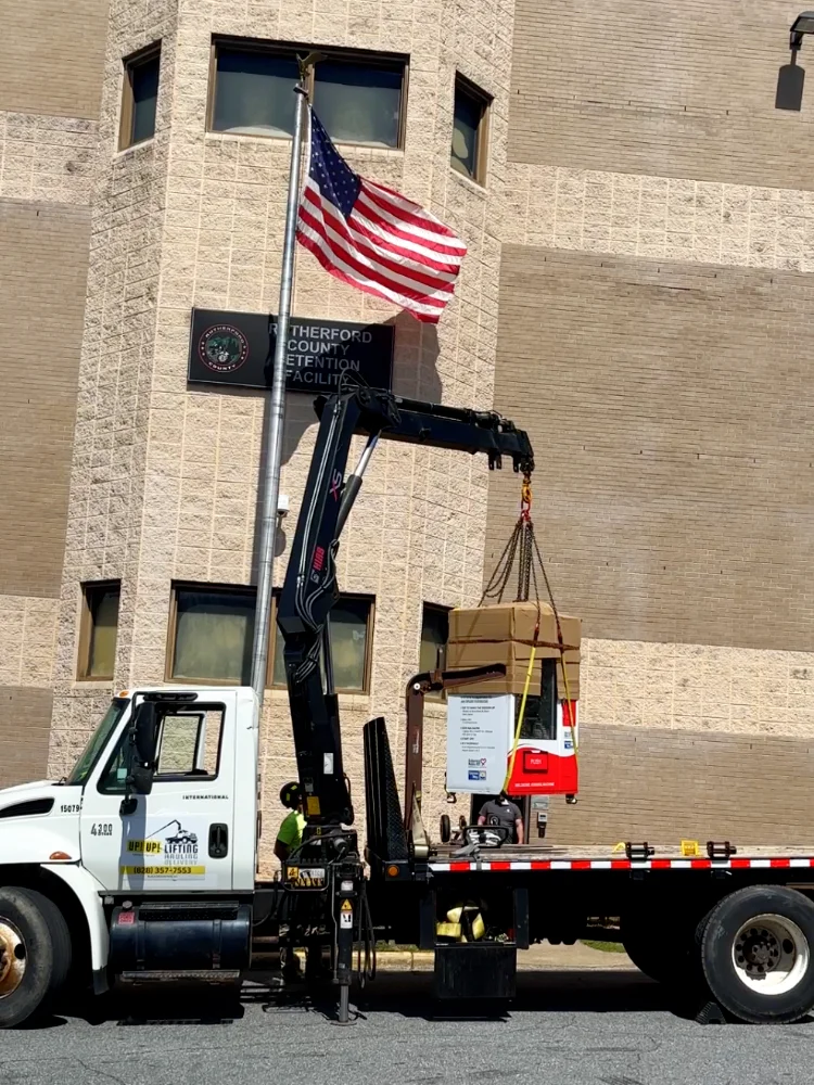 crane truck freight recovery with articulated knuckleboom crane, delivering vending machine in Rutherfordton, NC by Up! Up! Lifting