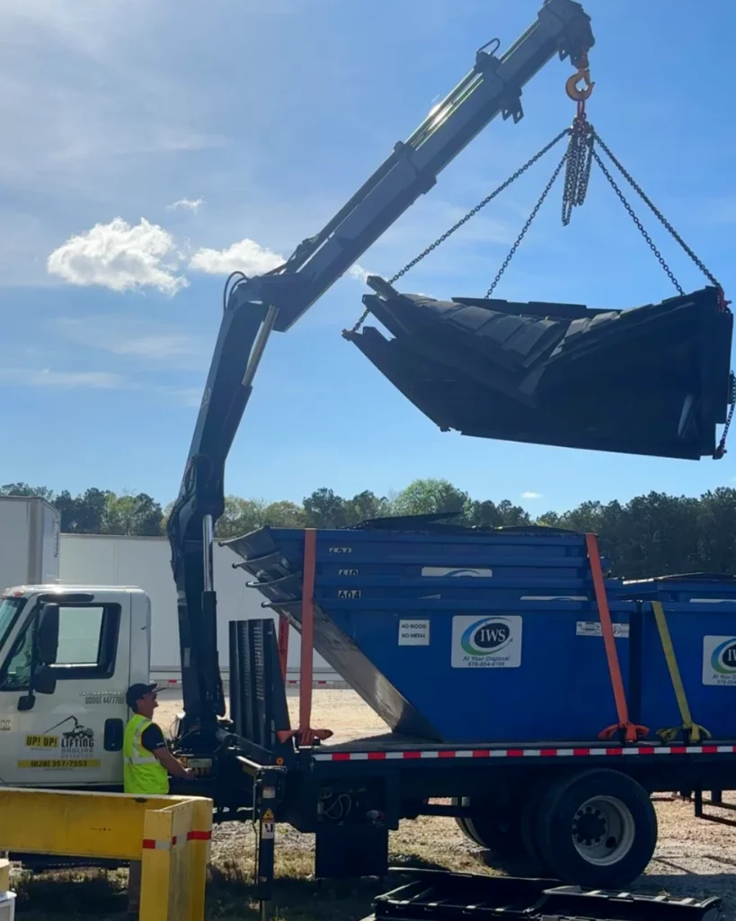 crane truck lifting stack of dumpster lids for transport and delivery in North Carolina by Up! Up! Lifting