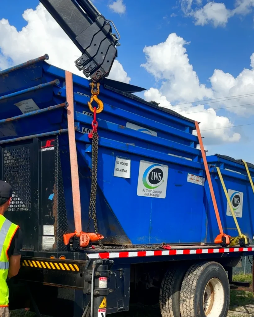 crane truck dumpster delivery of nested 6 yard dumpsters loaded onto flatbed by articulated truck-mounted crane by Up! Up! Lifting