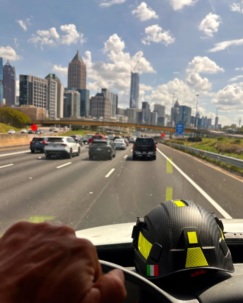 crane truck dumpster delivery driving through Atlanta GA to pickup and transport 6 yard dumpsters for North Carolina client