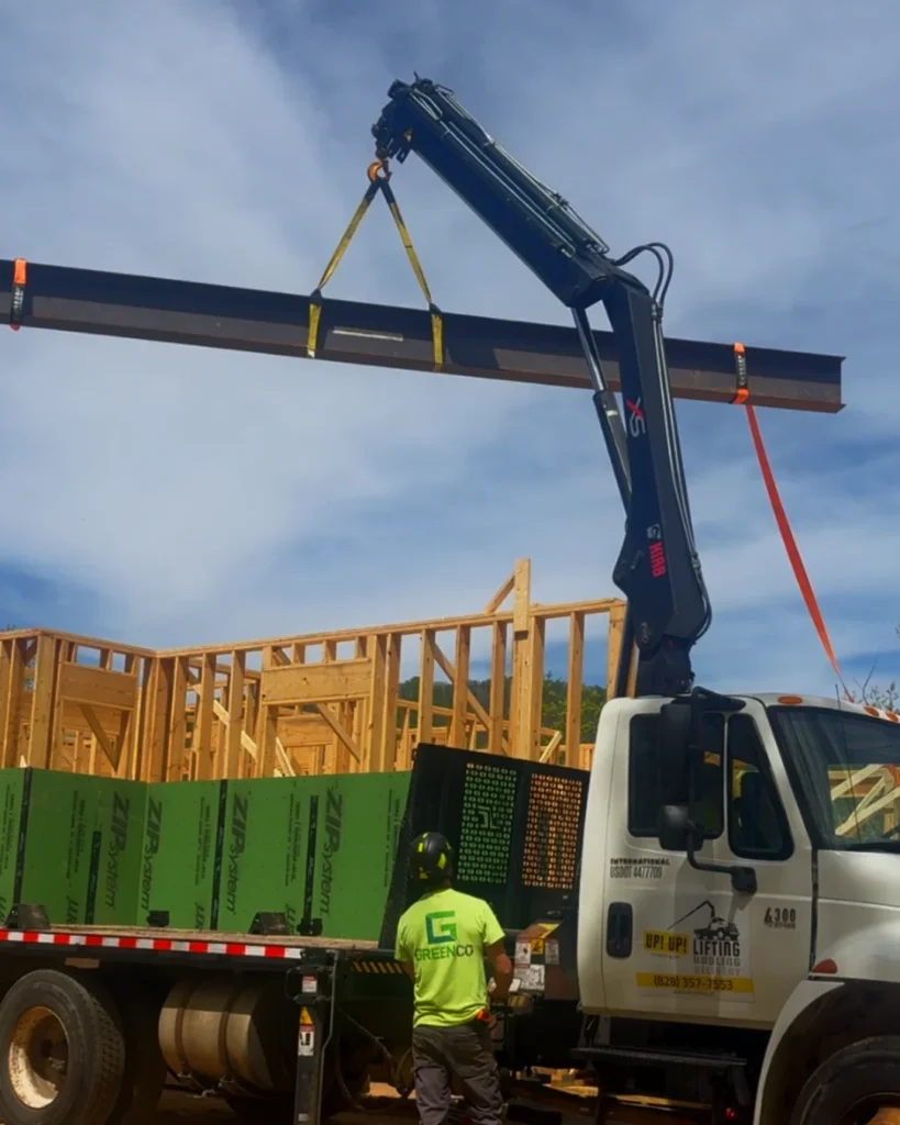 Crane truck lifting steel i-beam for new mountain home construction in Black Mountain NC by Up! Up! Lifting