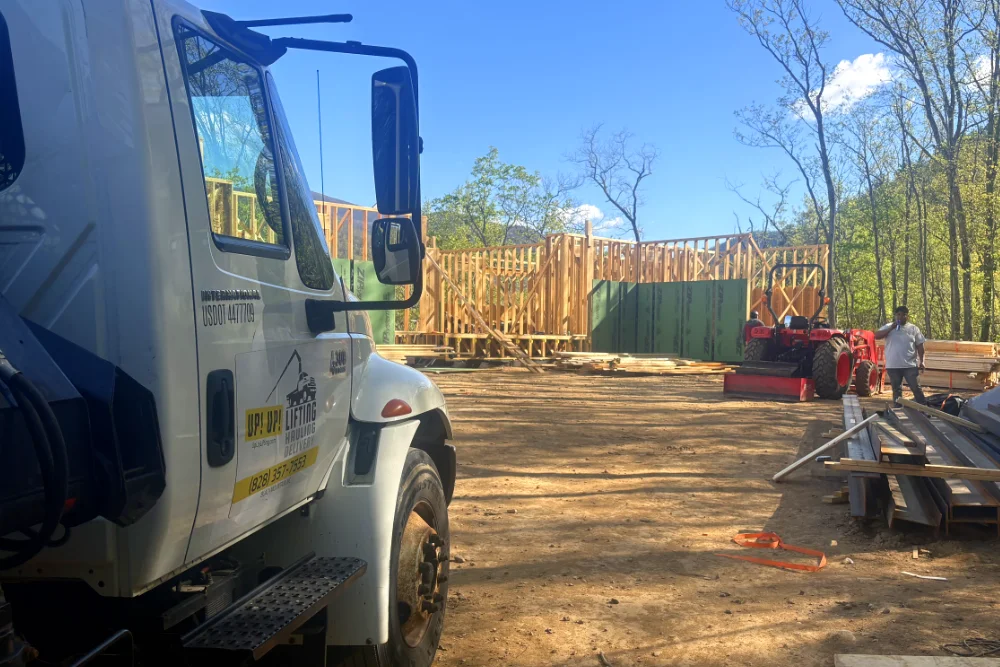 Up! Up! Lifting crane truck positioned beside a new home under construction in Black Mountain, NC